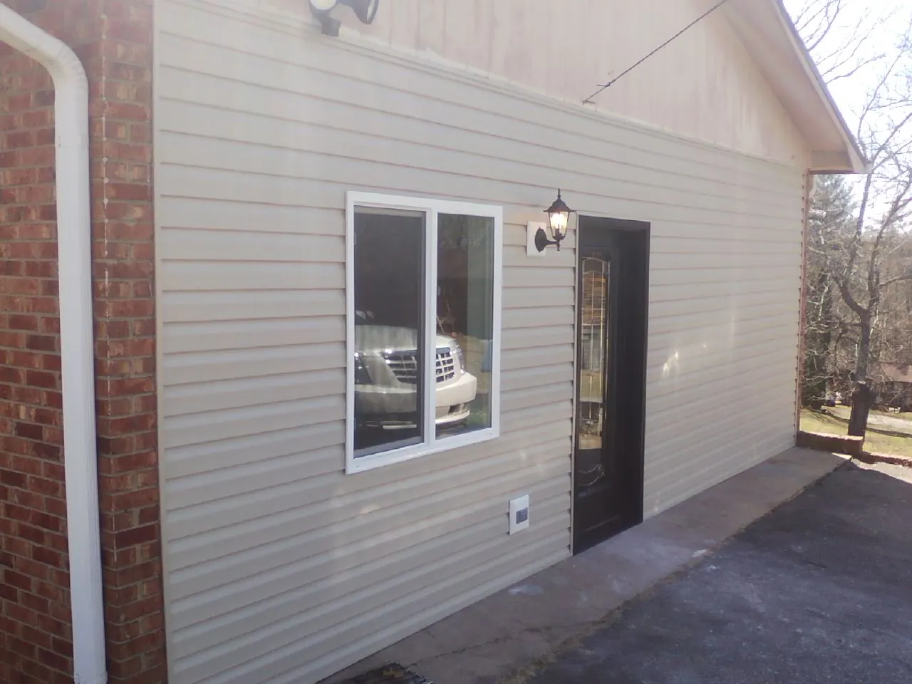 New vinyl siding and entry door on a room addition in Donaldson